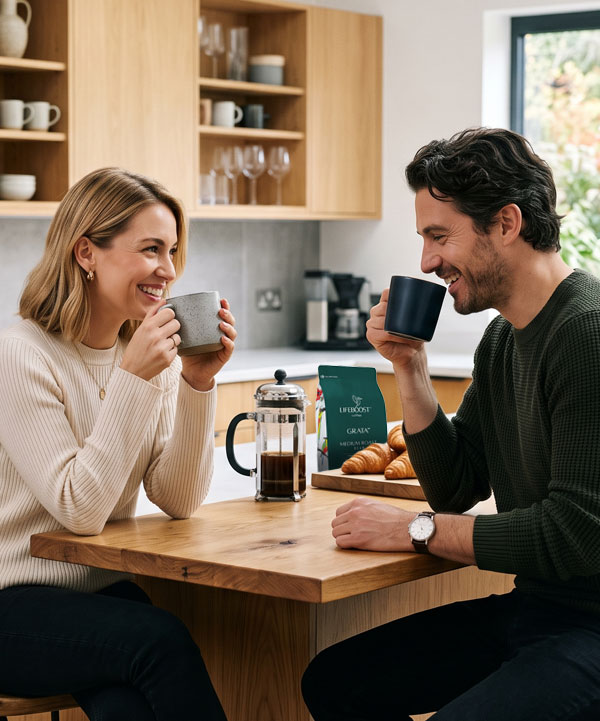 A couple enjoying Lifeboost coffee together at a kitchen table